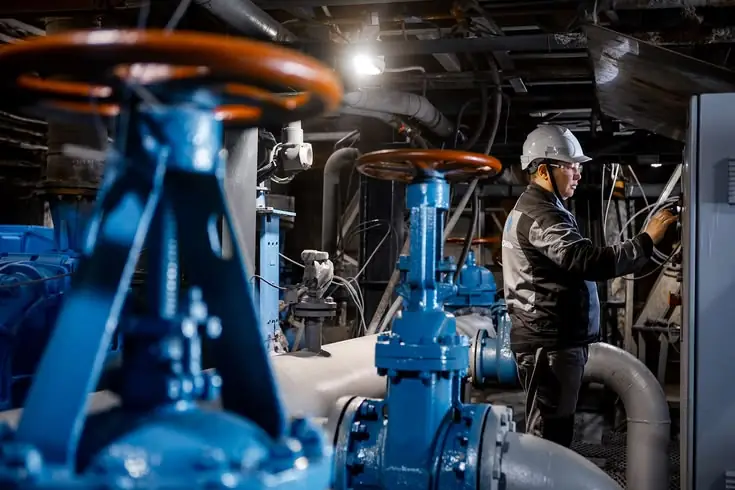 Technician inspecting fire protection pump and valve system
